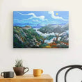 Load image into Gallery viewer, Colorful landscape painting on wall above wooden table with mugs and small potted cactus
