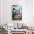 Charger l'image dans la visionneuse de la galerie, Living room with cozy sofa and striped pillows, floral street painting on white wall