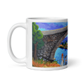 Charger l'image dans la visionneuse de la galerie, White mug with colorful Roman stone bridge, trees, river, and figures in an art panorama.
