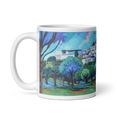 Load image into Gallery viewer, White ceramic mug featuring a colorful painted landscape with trees and village buildings
