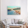 Charger l'image dans la visionneuse de la galerie, Colorful beach landscape canvas featuring cows on sand, waves, and mountains above a sofa.