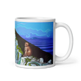 Load image into Gallery viewer, White ceramic mug with painted monkey, rocky cliff, and vivid blue ocean panorama