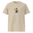 Cargar la imagen en la vista de la galería, Unisex organic cotton t-shirt in desert dust color with cartoon cat holding a red rose