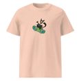 Cargar la imagen en la vista de la galería, Unisex organic cotton t-shirt in light peach with cartoon cat on skateboard graphic