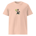 Cargar la imagen en la vista de la galería, Peach unisex organic cotton t-shirt with cartoon dog holding tennis racket graphic