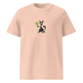 Carregar imagem no visualizador da Galeria, Peach unisex organic cotton t-shirt with cartoon dog holding tennis racket graphic