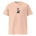 Carregar imagem no visualizador da Galeria, Unisex organic cotton t-shirt in peach with dog and golf club graphic on front