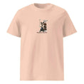 Carregar imagem no visualizador da Galeria, Unisex organic cotton t-shirt in peach with cartoon cat golfer and golf bag graphic