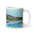 Cargar la imagen en la vista de la galería, White glossy 11 oz mug with Hawaiian coastal landscape featuring ocean waves, mountain range, and tropical trees