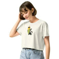 Carregar imagem no visualizador da Galeria, Woman in ecru crop top with cartoon dog and surfboard graphic, light blue jeans, white background