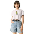 Charger l'image dans la visionneuse de la galerie, Woman wearing orchid crop top with cartoon cat and pencil graphic, paired with denim shorts