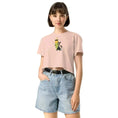 Charger l'image dans la visionneuse de la galerie, Woman wearing pale pink crop top with cartoon pencil and cat print, denim shorts